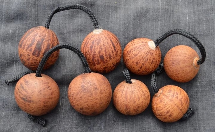Gourd Kashaka. Dried gourds containing beads and connected with string.